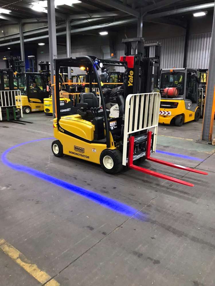 Blue arc projected around the forklift by ForkCast Lighting Solution