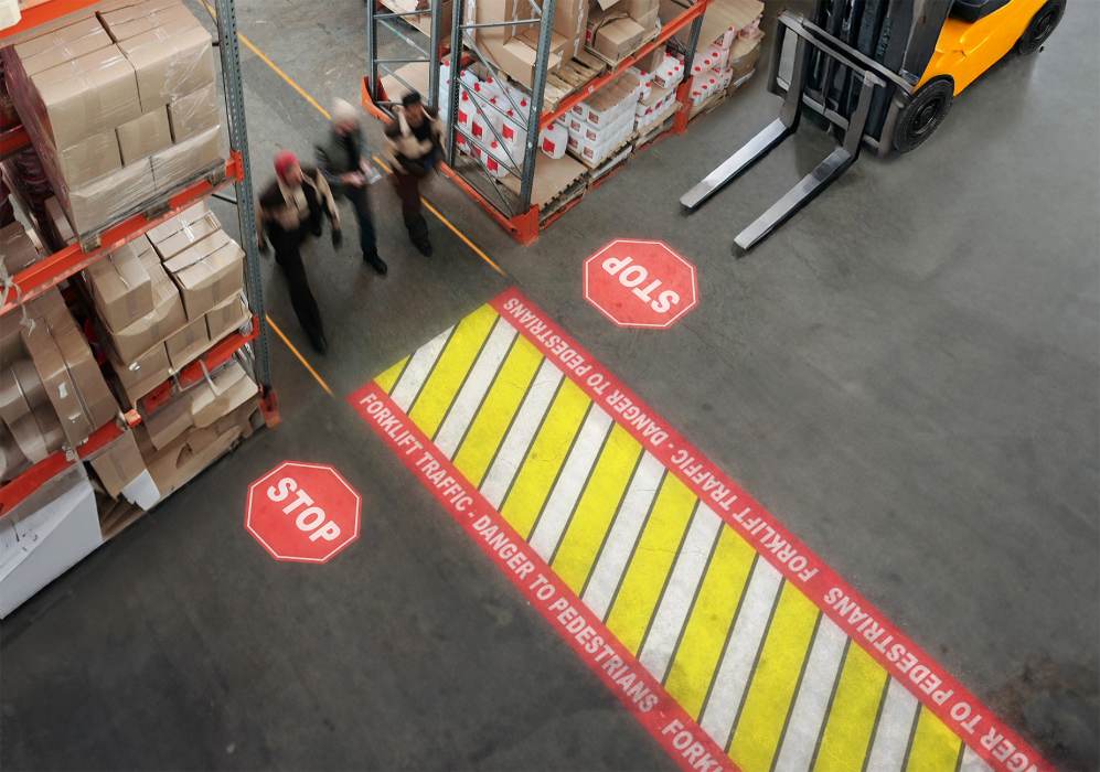 Laserglow's signs, lines, and walkways displayed in the warehouse aisle