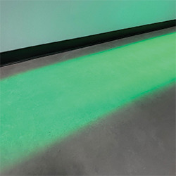 High-contrast green solid light projected onto the floor for path demarcation
