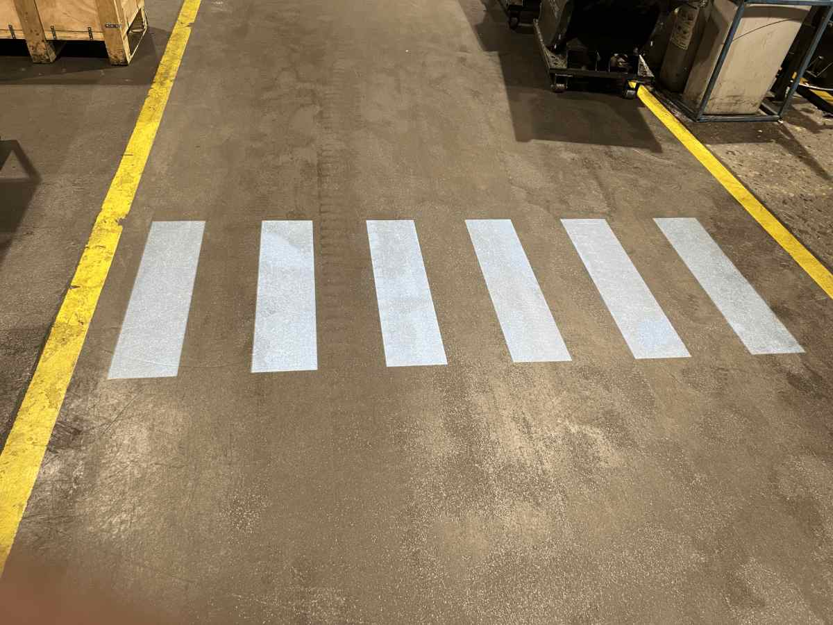 White crosswalk projected onto the warehouse floor