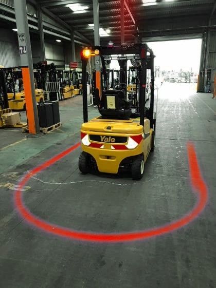 Red Arc projected by ForkCast MHE Lighting Solution in front of a forklift