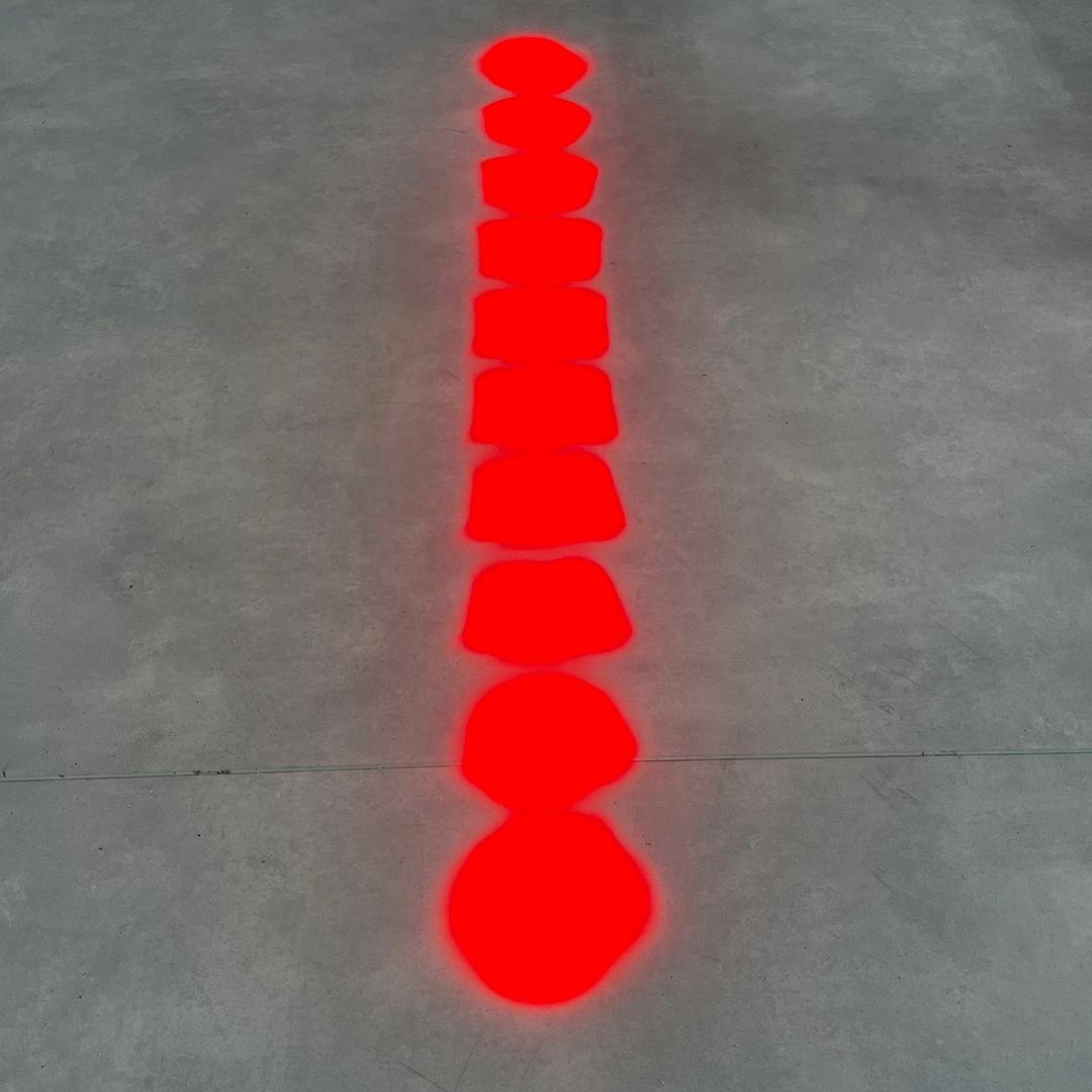 Red line of dots projected onto the floor
