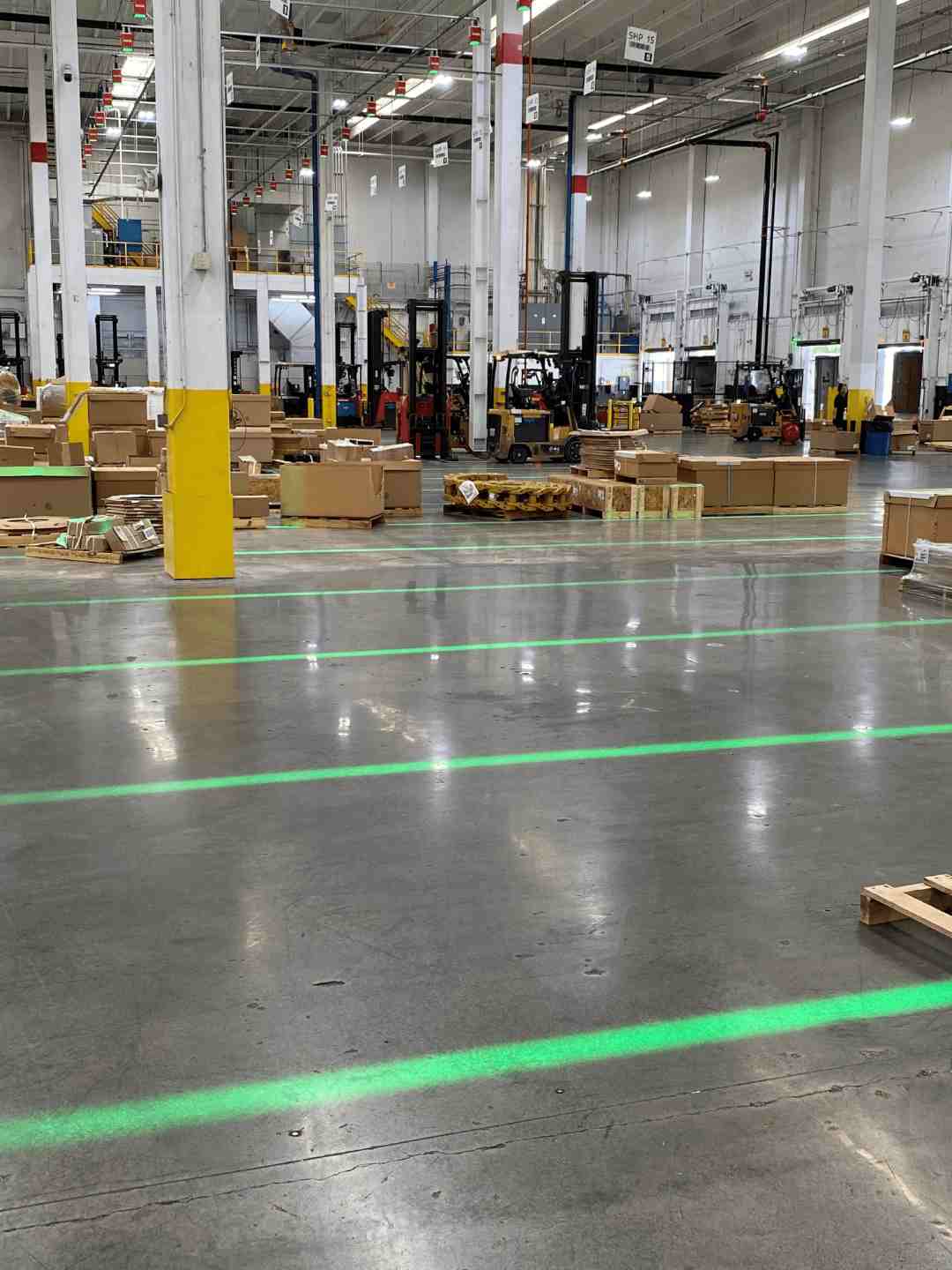Pallet staging areas marked by the green projected light
