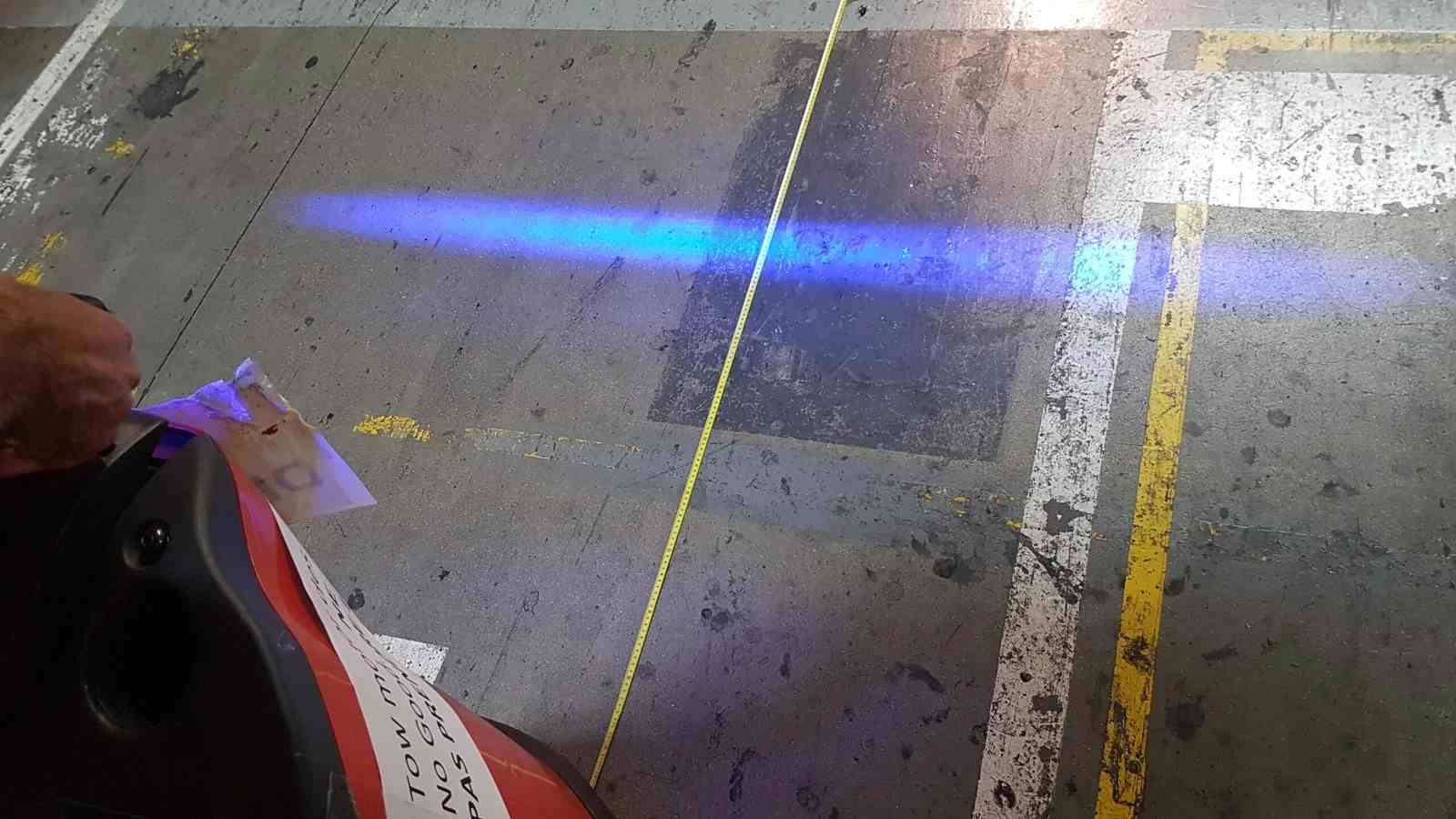Blue line projected onto the warehouse floor