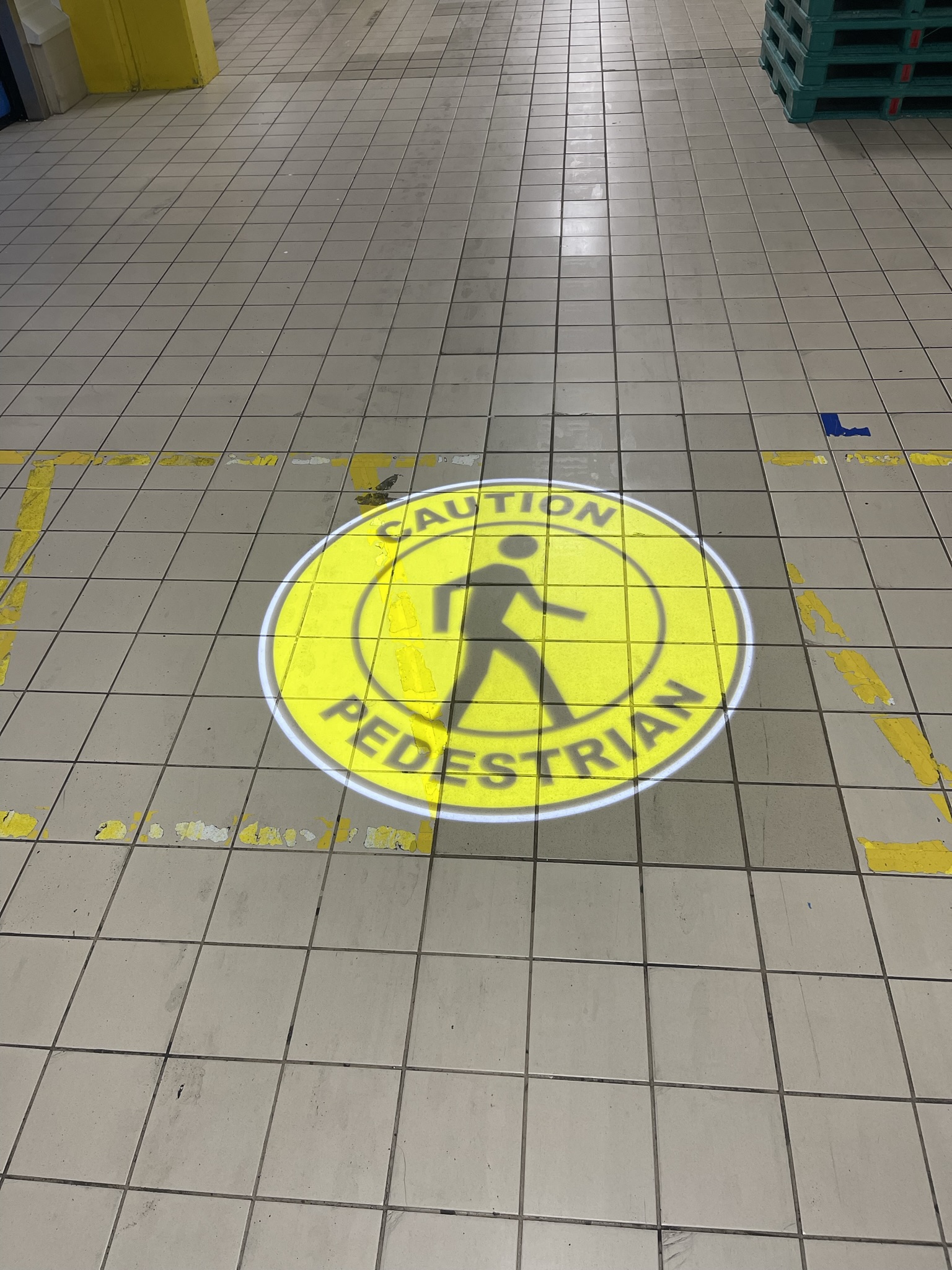 SafetyCast Projected "Caution" Sign on the rough floor